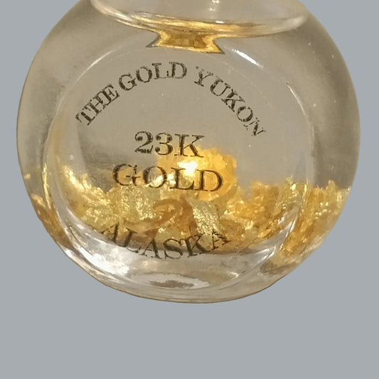 Alaska/Yukon souvenir bottle features decorative 23K gold flakes in clear liquid